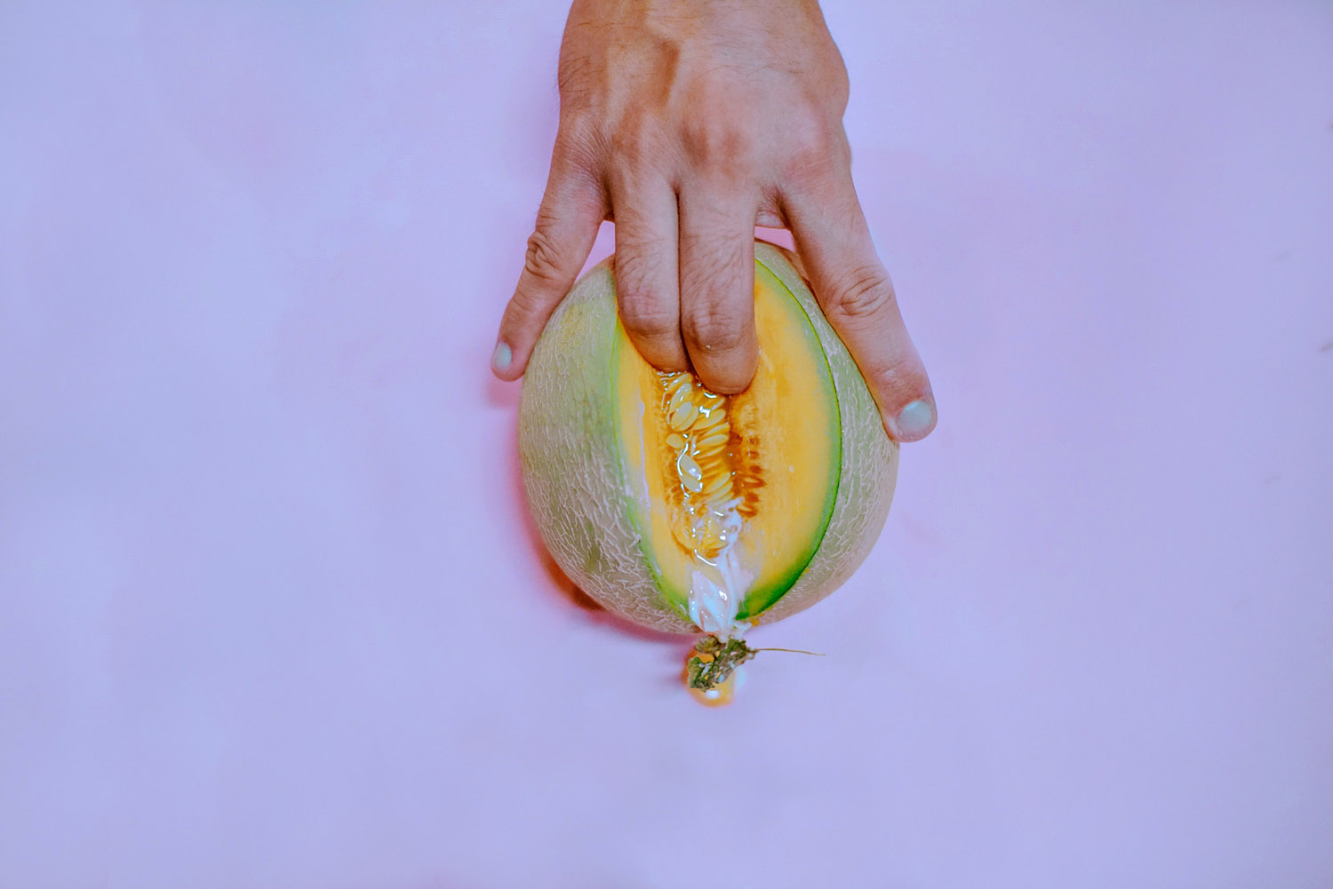 A man fingering a melon